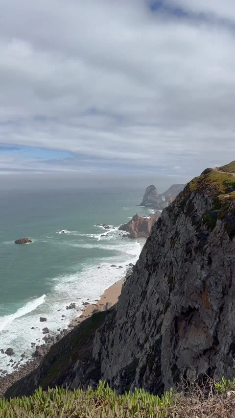 Stunning Cliffside Ocean View With Waves Crashing Against Rocky Shore In Portuga Stock Footage 302884472