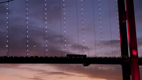 Stunning close up of red cable-stayed bridge with flow of cars. Sunset sky Video stock 252520558