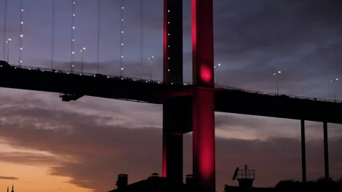 Stunning close up of red cable-stayed bridge with flow of cars. Sunset sky Stock Footage 252520584