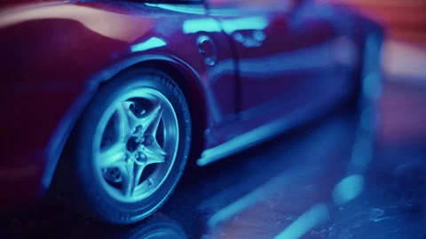 Stunning close-up of a red model car showcasing its detailed wheel design Stock Footage 319902562