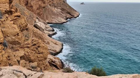 Stunning Coastal Cliffs with Lapping Ocean Waves Set in a Serene and Beautiful Stock Photos