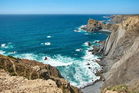 Stunning coastal view of steep cliffs meeting stormy Atlantic Ocean Stock Photos