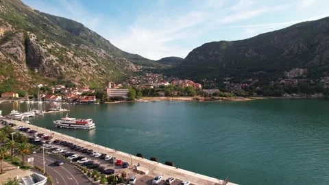 Stunning coastal view of a tranquil harbor surrounded by majestic mountains Stock Footage 320746179