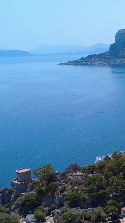 Stunning Coastal View of Tranquil Waters and Distant Mountains From a Cliffside Stock Footage 311111456