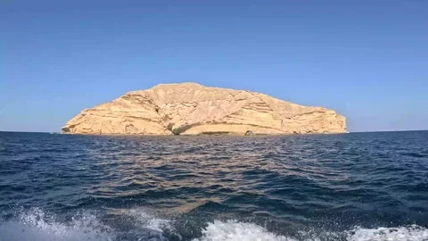 The stunning contrast of steep, golden cliffs rising majestically  Stock Footage 295907850