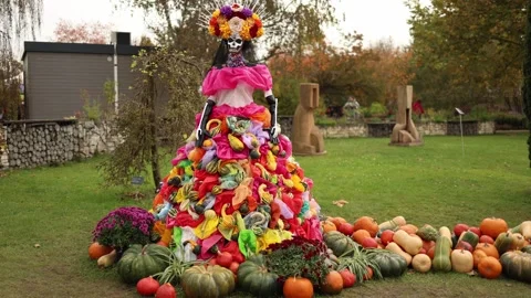 A stunning Day of the Dead figure adorned with a vibrant floral crown and an ela Stock Footage 289655707