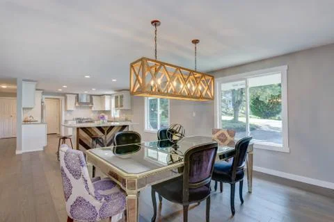 Stunning dining area with mirrored table, velvet chairs and rectangular  rust Stock Photos