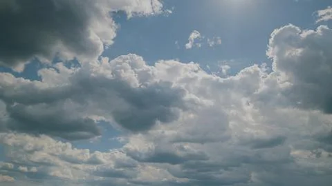 A stunning display of dynamic cloud patterns gracefully drifting under the brigh Stock Photos