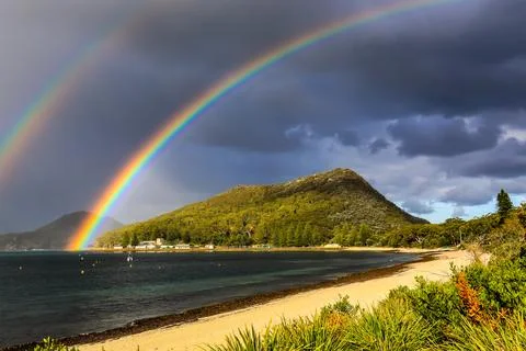 Stunning double rainbow arching over Tomaree Mountain Stock Photos
