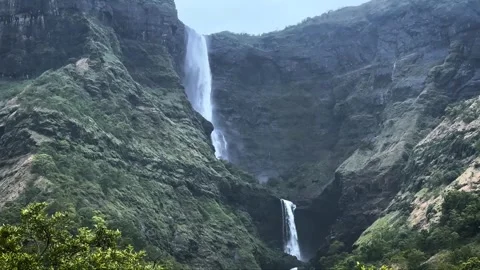 Stunning Downside View of Waterfall Cascading from Mountains Stock Footage 285073313