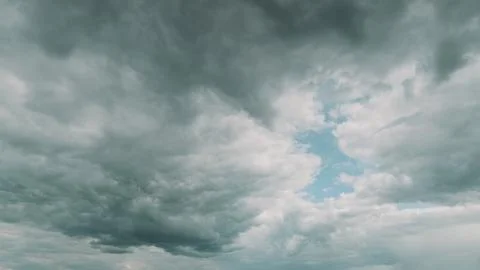 A stunning dramatic cloudscape featuring a vivid blue sky peeking through the cl Foto stock