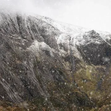 Stunning dramatic landscape image of snowcapped Glyders mountain range in Sno Stock Photos