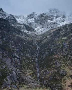 Stunning dramatic landscape image of snowcapped Glyders mountain range in Sno Stock Photos