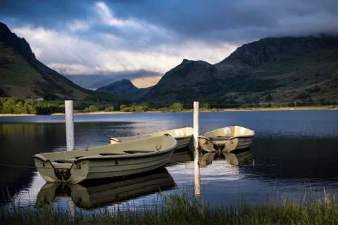 Stunning dramatic stormy sky formations over breathtaking mountain lake lands Stock Photos