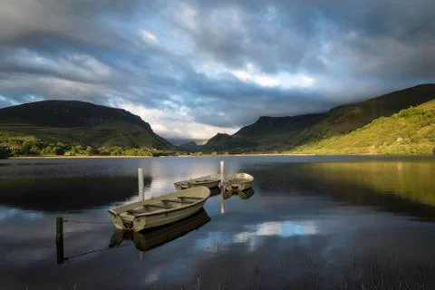 Stunning dramatic stormy sky formations over breathtaking mountain lake lands Stock Photos