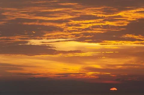 Stunning dramatic sunset over the ocean. Stock Photos