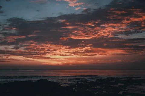 Stunning dramatic sunset over the ocean. Stock Photos