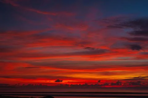 Stunning dramatic sunset over the ocean. Stock Photos