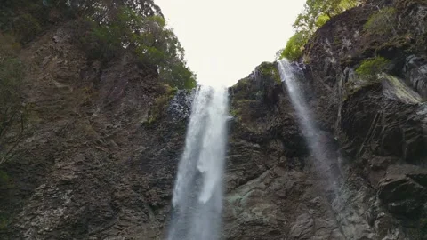 Stunning Drone Ascent Showcasing Hidden Mountain Waterfall Stock Footage 336588765