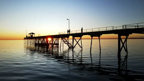 Stunning drone jetty silhouette sunset Stock Footage 203443473