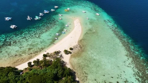 Stunning drone shot of Bulog Dos Island, with its clear blue waters and tropical Stock Footage 295913448