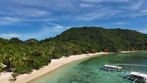 Stunning drone shot of Coco Beach, capturing the serene coastline and lush Stock Footage 295913822
