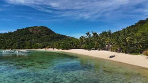 Stunning drone shot of Coco Beach, capturing the serene coastline and lush Stock Footage 295913924