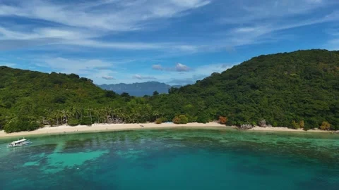 Stunning drone shot of Coco Beach, capturing the serene coastline and lush Stock Footage 295914175