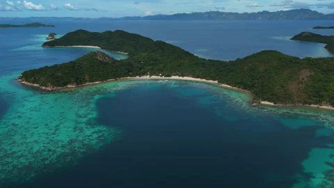 Stunning drone shot of Coco Beach, capturing the serene coastline and lush Stock Footage 295914333