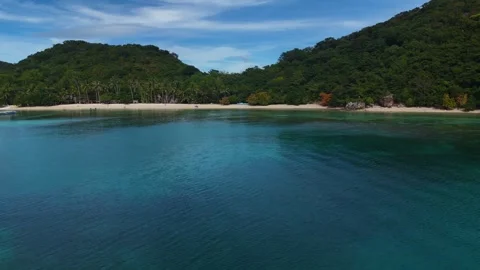 Stunning drone shot of Coco Beach, capturing the serene coastline and lush Stock Footage 295914563