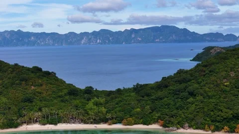 Stunning drone shot of Coco Beach, capturing the serene coastline and lush Stock Footage 295914755