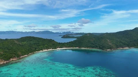Stunning drone shot of Coco Beach, capturing the serene coastline and lush Stock Footage 295914998