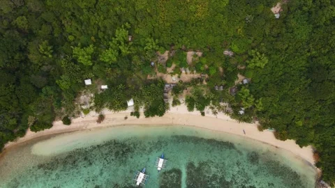 Stunning drone shot of Coco Beach, capturing the serene coastline and lush Stock Footage 295915184