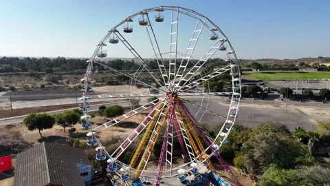 A stunning drone shot of a Ferris wheel in an amusement park Stock Footage 294261836