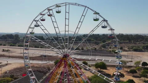 A stunning drone shot of a Ferris wheel in an amusement park Stock Footage 294723153