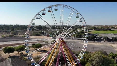 A stunning drone shot of a Ferris wheel in an amusement park Stock Footage 294723237