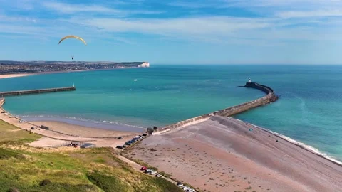 A stunning drone video capturing a paraglider soaring above dramatic Stock Footage 283344086