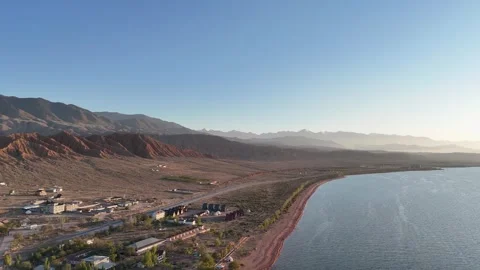 Stunning drone view of Issyk-Kul Lake at sunset, showcasing golden skies Stock Footage 328943766