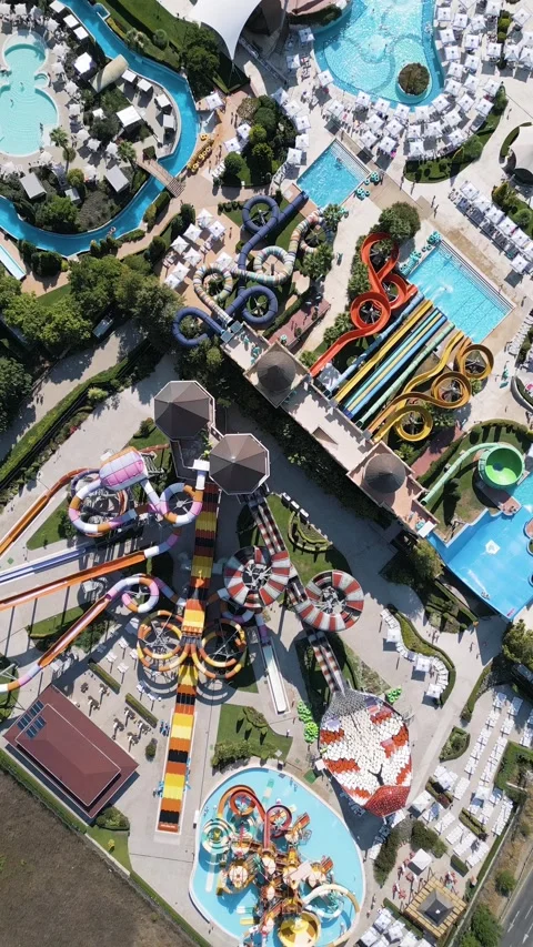 Stunning drone view of a massive water park filled with colorful slides, pools Stock Footage 316828700