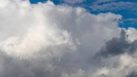 Stunning dynamic cloud patterns beautifully contrasting against a bright, clear Stock Photos