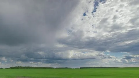 Stunning Dynamic Cloud Patterns Gracefully Drift Over Lush Green Agricultural Fi Stock Photos