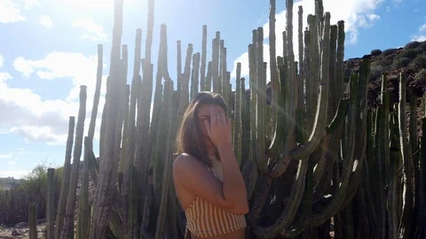 Stunning Female Model Posing with Cactus and White Clouds in Background 스톡 동영상 112023483