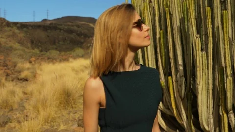 Stunning Female Model Posing with Cactus and Other Plants in Background Video stock 114172116