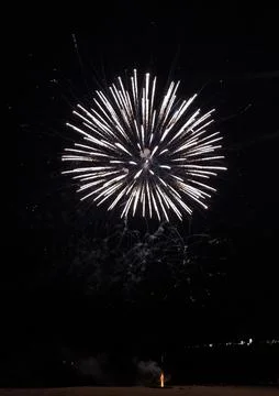 Stunning firework display exploding in a radiant burst of white light again.. Stock Photos