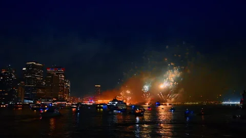 Stunning firework show at the festive celebration at night. New York skyline and Stock Footage 316575997