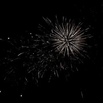 Stunning fireworks display explodes across a dark night sky, creating a vib.. 스톡 사진