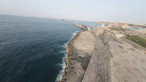 Stunning flight over the pier next to the cozy bay of Valletta RAW video Stock Footage 248782477