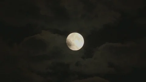 Stunning Full Moon appearing from behind the clouds Stock Footage 80033429