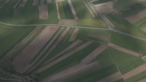 Stunning geometric patchwork of agricultural fields with fast moving dynami.. Video stock 336854397