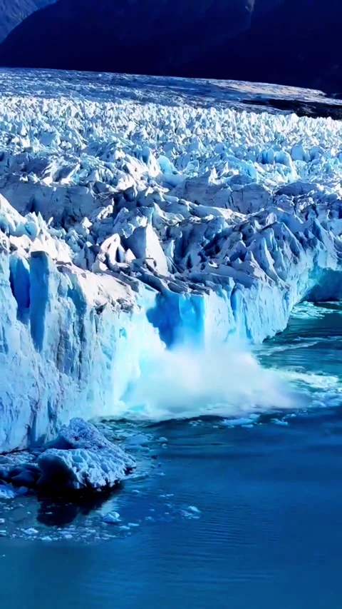 Stunning glacial ice formation calving into pristine blue water in a powerf.. Stock Footage 331482260
